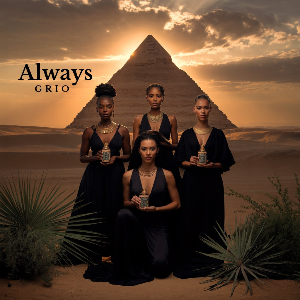 Four women dressed in deep blue stand in the desert before the Great Pyramid at sunset, each holding a bottle of Grio’s Curve Enhancing Oil — symbolizing ancestral beauty, unity, and the timeless power of self-care passed through generations.